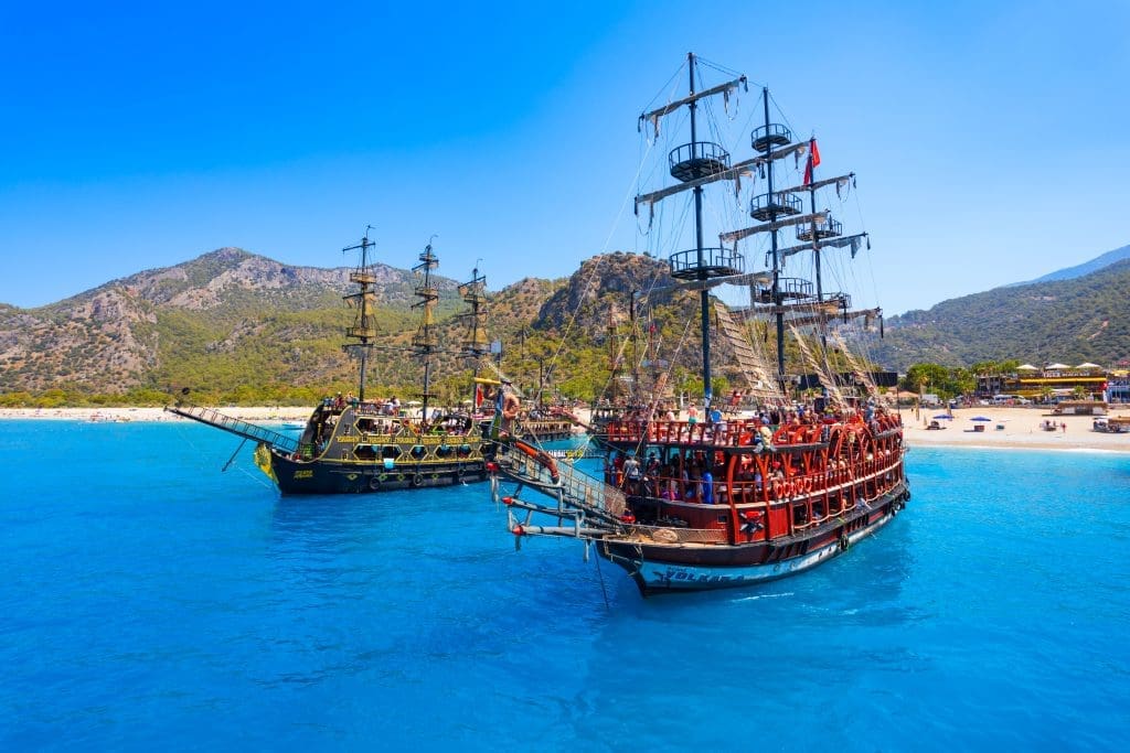 Two pirate ships anchored in Alanya’s turquoise sea near the beach