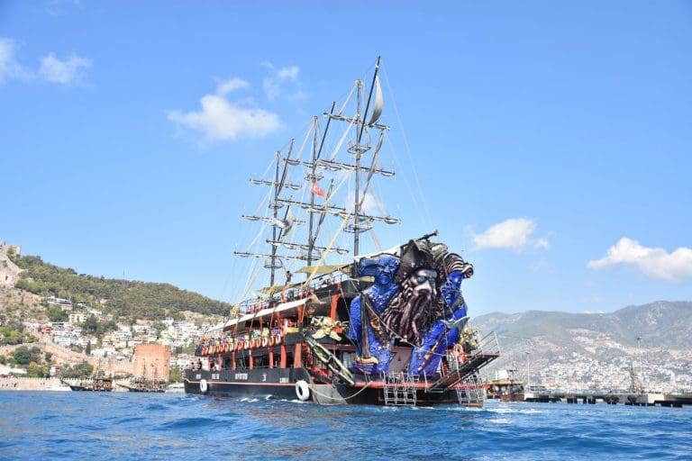 Alanya pirate boat decorated with octopus figurehead sailing near harbor