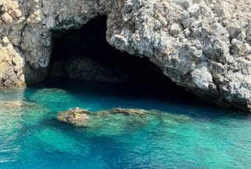Alanya pirate boat sailing past the caves near the castle